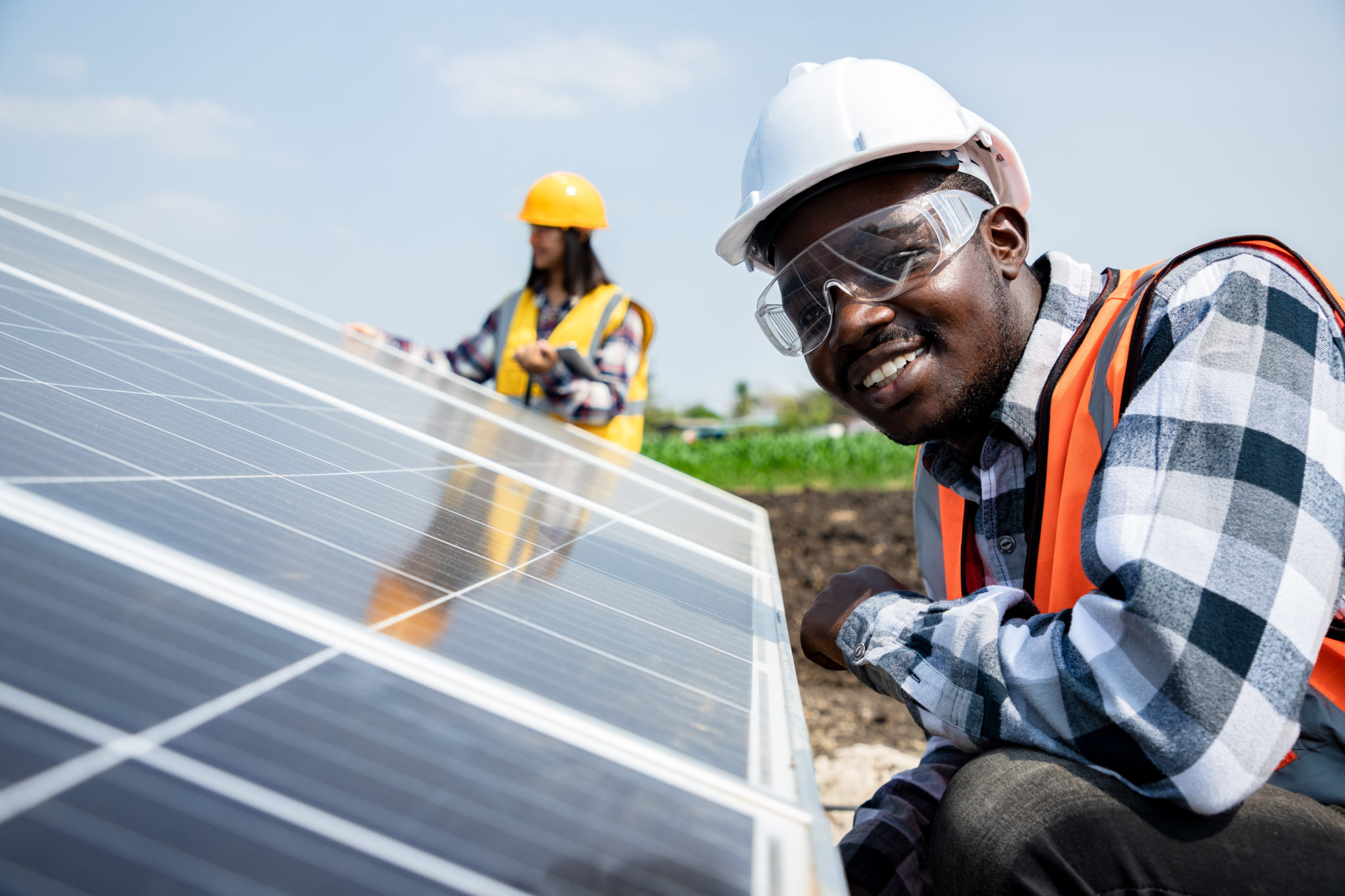 Two workers technicians installing heavy solar photo voltaic pan