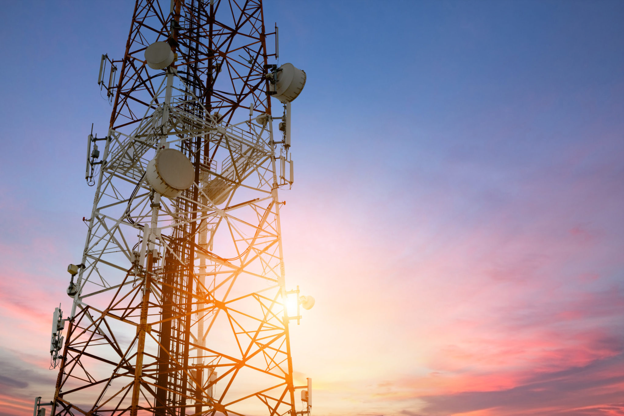 Satellite dish telecom network at sunset communication technology network